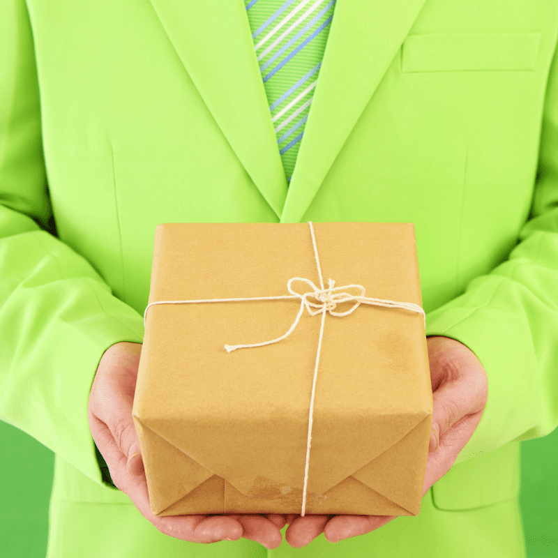man dress in neon green holding delivery box depicting courier services