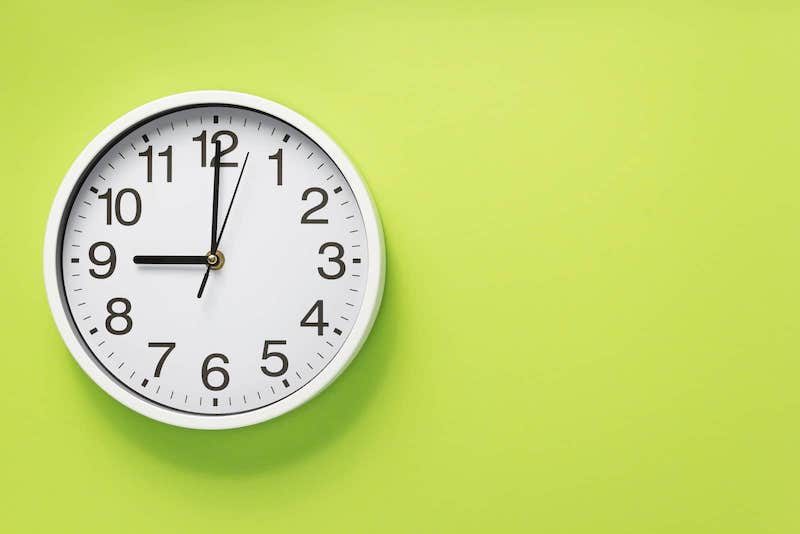 Clock on Bright Green Background depicting Expedited Shipping