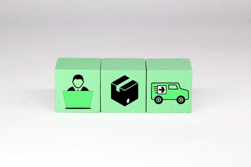 green colored cubes depicting shipping logistics online buyer package truck