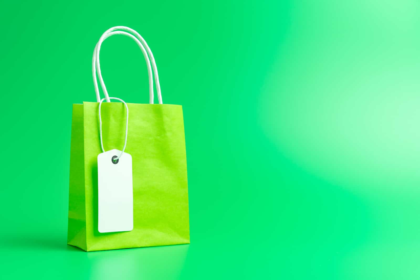 green gift bag on green background increase online sales concept