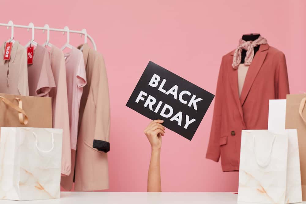 Black friday sale sign surrounded by clothing