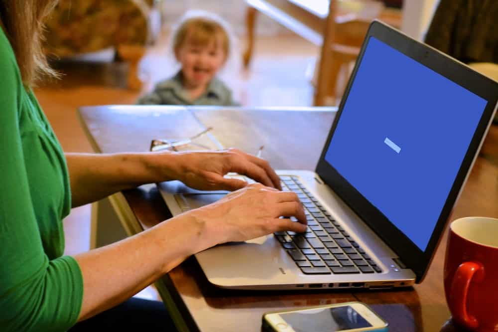 person working from home based business with toddler in background